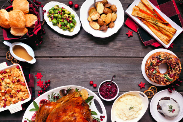 istock Classic Christmas turkey dinner. Top view frame on a dark wood background. 1350454578