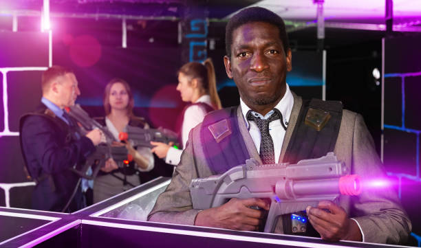 istock Afro businessman playing laser tag 1350456431