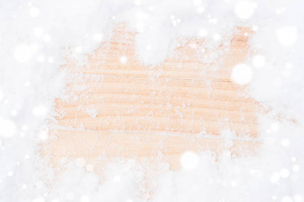 Snow wood background. Winter wooden texture backdrop. Christmas board with old rustic wall, white frozen ice. Top view with copy space