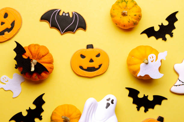istock Composition with homemade cookies, pumpkins, bats, ghosts on yellow background 1350459176