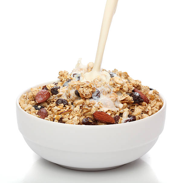 istock Pouring milk into a bowl with granola cereal 135045968