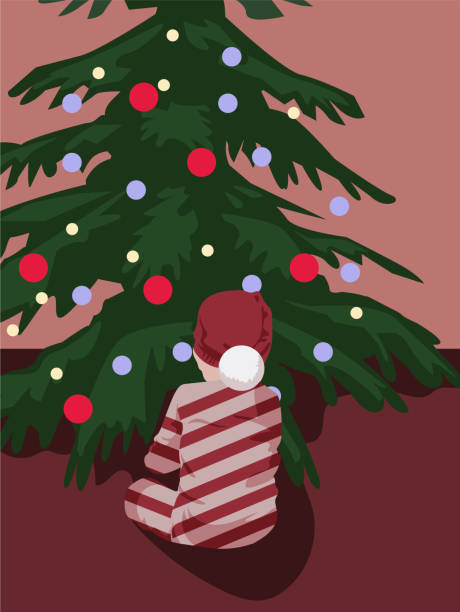 istock A child sits in front of a Christmas tree in a New Year's costume 1350461523