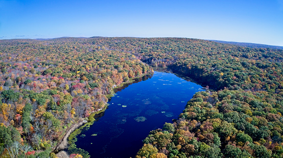 Aerial view of autumn foliage and mountain lake.