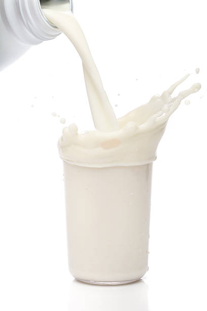 istock Bottle pouring milk into a glass. Splash 135046388