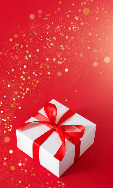 istock gift box on red background with red bow with place for text 1350465428