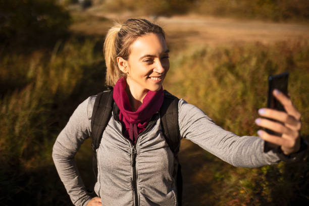 istock Young woman hiking making a selfie 1350470518