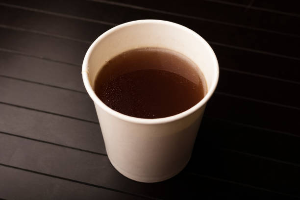 istock paper glass with delicious beef broth, dark background 1350481241