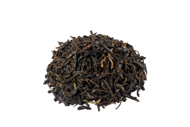 istock yunnan black tea heap isolated on white background. 1350482976