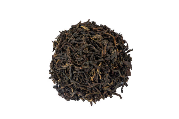 istock yunnan black tea heap isolated on white background. 1350482993