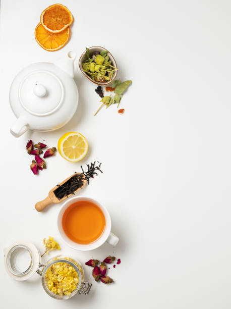 istock Flat lay a cup of black tea, fruit and herbal tea, with lemon and tea pot on a white background. The concept of a healthy drink. Top view and copy space 1350483601