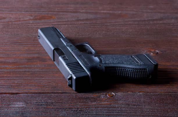 istock gun on a wooden table 1350488887