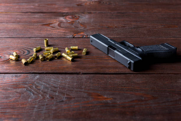 istock gun on a wooden table 1350488974