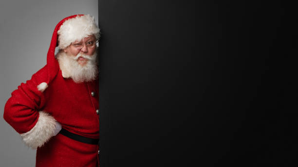 istock Santa Claus holding banner 1350489528