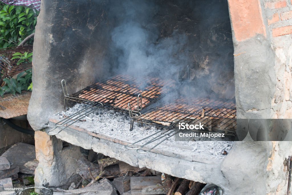 Big barbacue with two cooking grids with lamb chops and pork secret Big barbacue with two cooking grids with lamb chops and pork secret. Outdoors Cooking Stock Photo