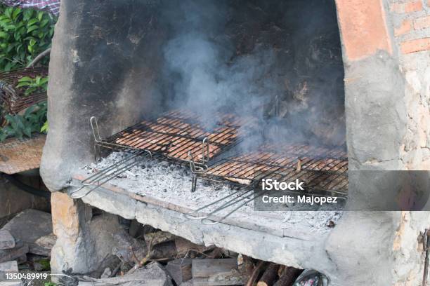 Big Barbacue With Two Cooking Grids With Lamb Chops And Pork Secret Stock Photo - Download Image Now