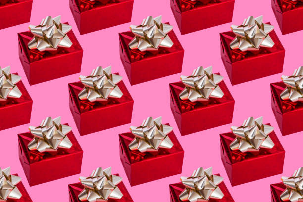 istock Boxing Day. christmas composition. Red gift with a gold bow on a pink background. pattern. 1350491150