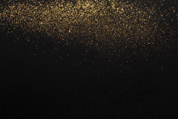 istock Gold glitter on black background. Holiday abstract texture 1350491380