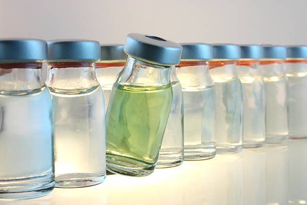Medical bottles A bottle with yellow liquid among  other bottles. medicine vial stock pictures, royalty-free photos & images
