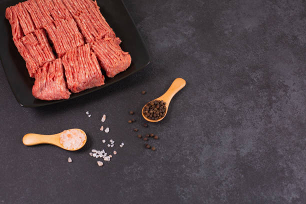istock Fresh raw minced beef, pork on back plate with salt pepper 1350492515