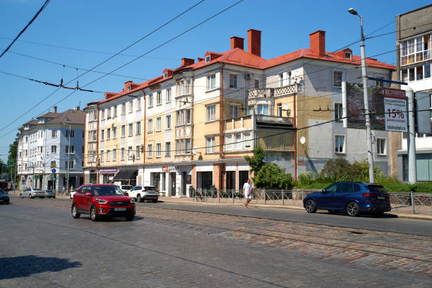 Kaliningrad, Russia - June 20, 2021. Street view in the Kaliningrad city (formerly Konigsberg). Old german multistorey house, pavement road