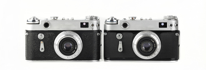 Old film rangefinder cameras produced from 50's on white background.
