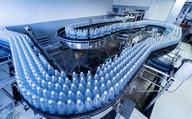 istock Conveyor belt with bottles of drinking water at a modern beverage plant. 1350498549