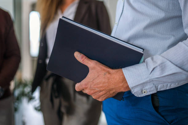 istock Businessman Holding a Notebook in His Hands 1350504484