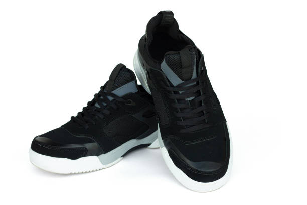 istock Black men's sneakers with white soles isolated on white 1350506629