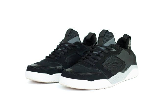 istock Black men's sneakers with white soles isolated on white 1350506631