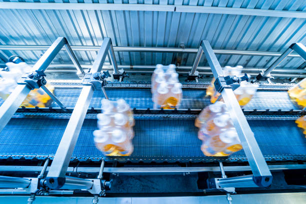 istock Modern strapping and transporting machine for packaging line at beverage plant. 1350507627