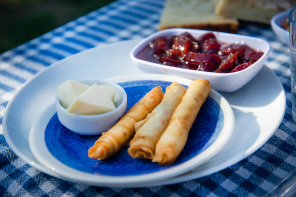 Traditional Turkish breakfast image. There are spring rolls,butter and jam on the table