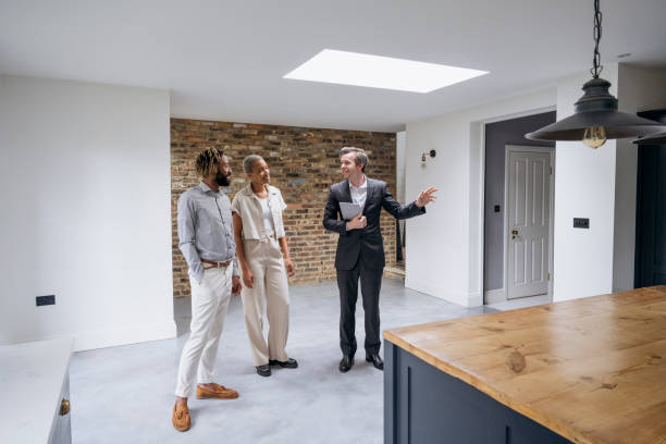 istock Sales representative showing home to prospective buyers 1350512521