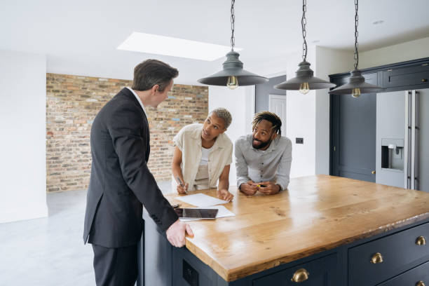 Potential home buyers signing preliminary contract agreement