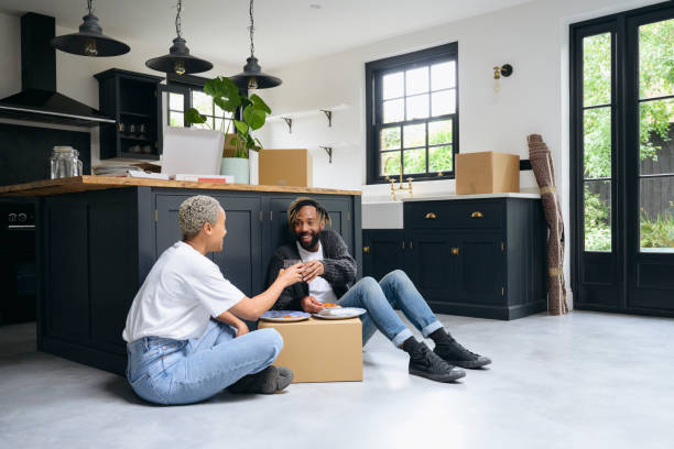 istock Black couple taking a break for pizza and wine on moving day 1350512547