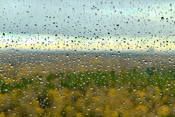 Many water drops on glass during rain, glass close up