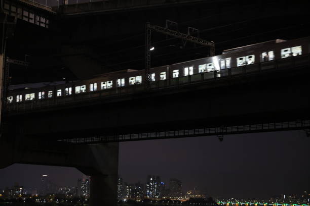 istock train passing by bridge railroad at night 1350514215