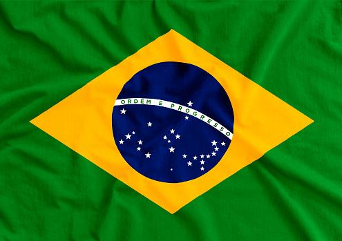 Brazil flag on wavy fabric. Translation: order and progress