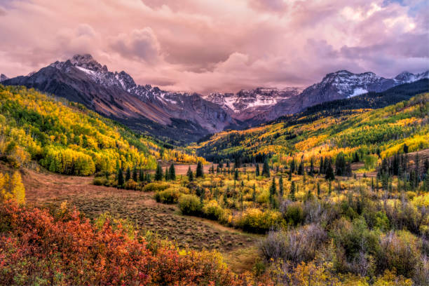 Dallas Creek Valley Sunset A colorful valley with the East Fork of Dallas Creek and WIllis Swamp with dramatic Fall colors below Mount Sneffels and moody sunset clouds in the San Juans Mountains of Southwest Colorado. sneffels range stock pictures, royalty-free photos & images