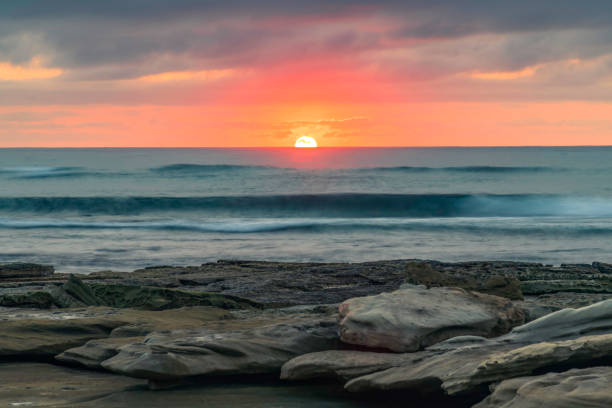 istock Sunrise seascape with rocky foreground 1350520727