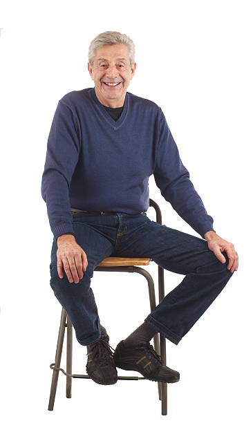 istock Happy senior man sits with hands on knees. 135052544