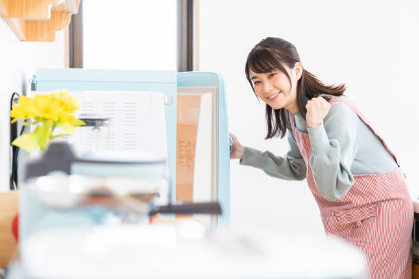 istock attractive asian woman cooks in a kitchen,Refrigerator 1350528227