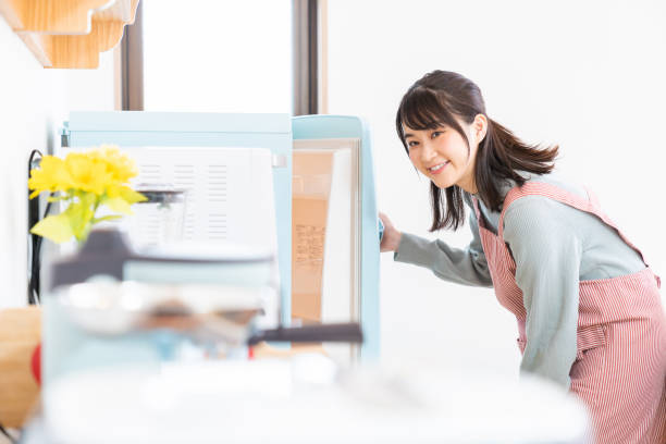 istock attractive asian woman cooks in a kitchen,Refrigerator 1350528270