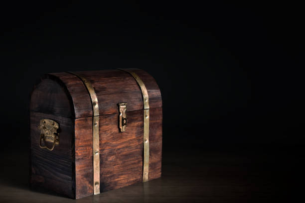 istock Wooden treasure chest on dark background 1350529994