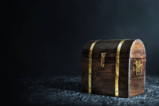istock Wooden treasure chest on dark background 1350529999
