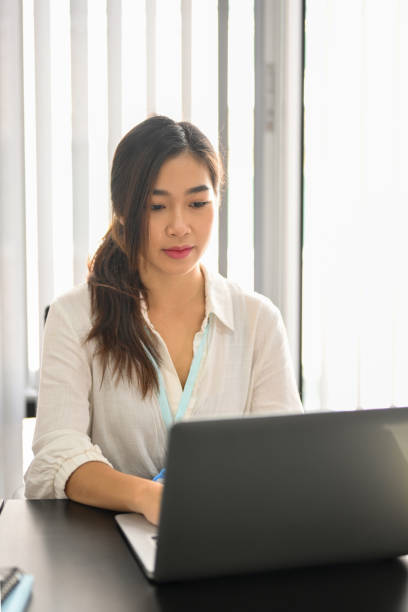 istock Business female employee focused on her project, working on laptop 1350530768