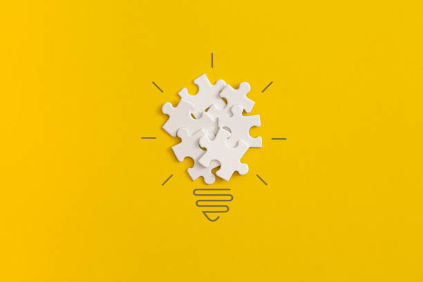 istock Light bulb from puzzles on yellow background. Inspiration and creative idea concept. Top view with copy space. Flat lay composition. 1350532080