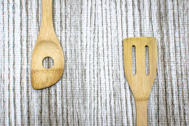 istock Wooden utensils on tablecloth with wood pattern.Top View 1350533985