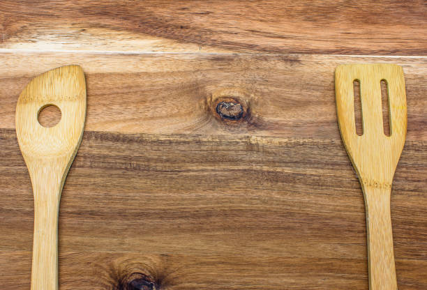 istock Wooden kitchen tools on wooden cutting board top view 1350533998