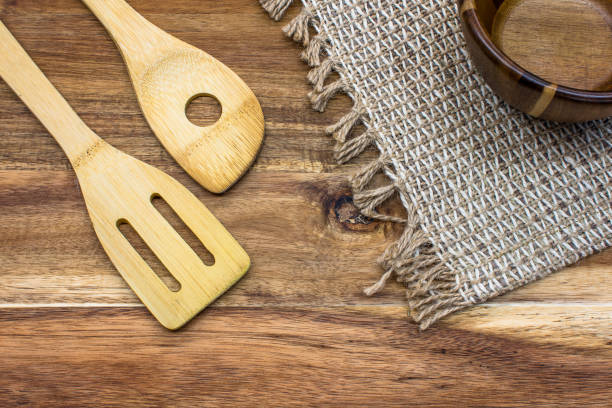 istock Wooden kitchen tools on wooden cutting board top view 1350534023