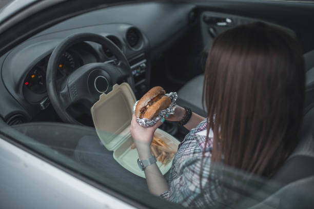 istock Female eating hamburger on a lunch break 1350539184